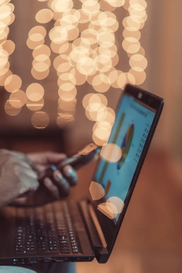 Man using laptop and mobile phone.