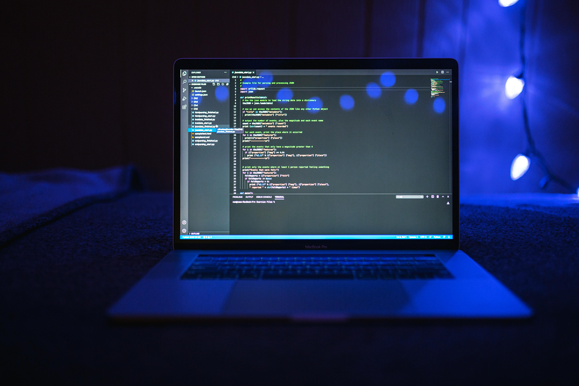 Laptop displaying code in low light
